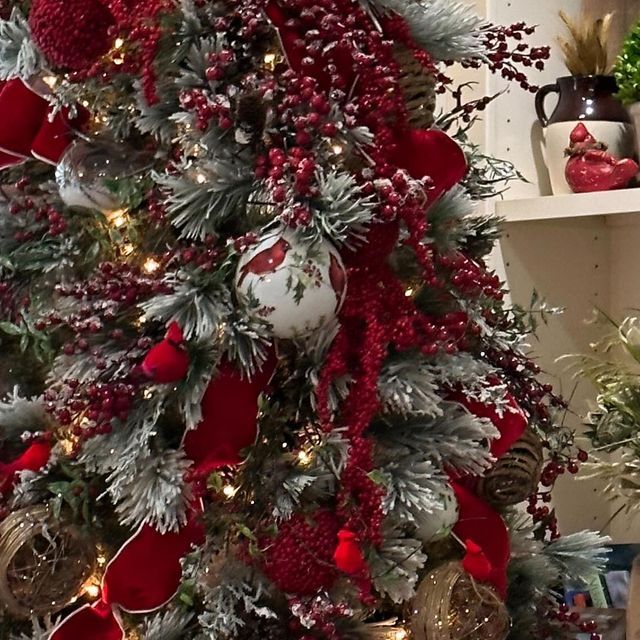 a christmas tree decorated with red and silver ornaments