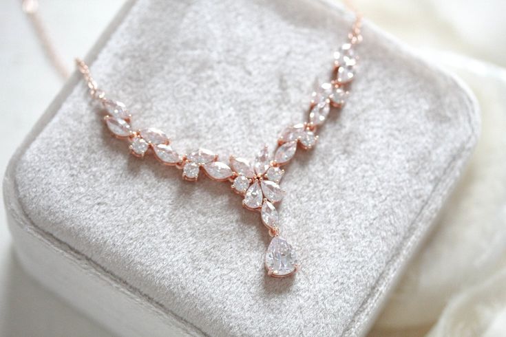 Ultra feminine with no shortage of sparkle, our Simple rose gold bridal necklace is perfect for adding a touch of glamour to your bridal look. Crafted with cubic zirconia stones, this necklace will become a forever favorite. - Created with Premium Cubic Zirconia stones- Available in rose gold, yellow gold, and rhodium finish.- Necklace measures 16 inches and extends to 18 inches- Decorative portion measures 3 inches- Decorative center drop measures 1.2 inches- Nickel free and hypoallergenic- PLE Elegant Rose Gold Crystal Bridal Necklace, Glamorous Rose Gold Necklaces For Party, Glamorous Rose Gold Party Necklace, Elegant Rose Gold Rhinestone Necklace For Wedding, Elegant Rose Gold Bridal Necklace For Party, Rose Gold Crystal Necklaces For Formal Occasions, Delicate Rose Gold Diamond Necklace For Wedding, Rose Gold Brilliant Cut Diamond Necklace For Wedding, Rose Gold Diamond Necklace With Brilliant Cut For Wedding