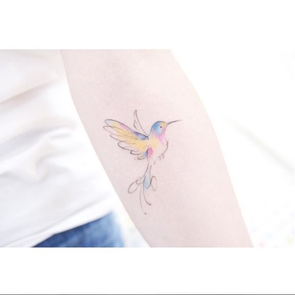 a small bird tattoo on the right arm