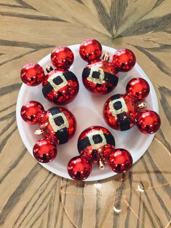 some red and black ornaments on a white plate