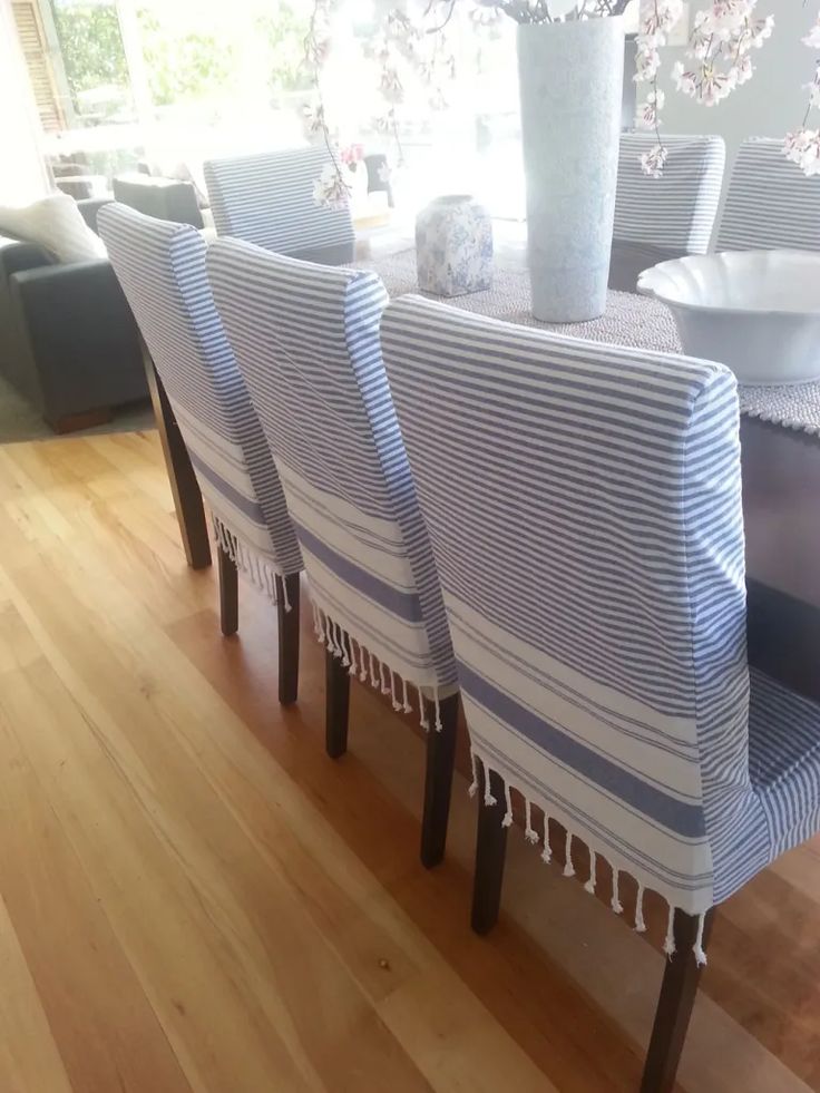 a dining room table with blue and white striped chairs