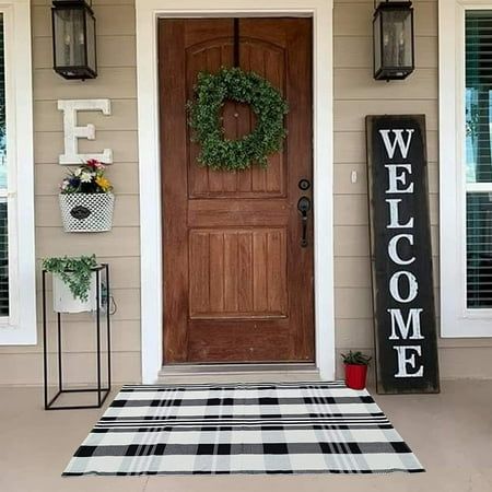 a welcome sign on the front door of a house