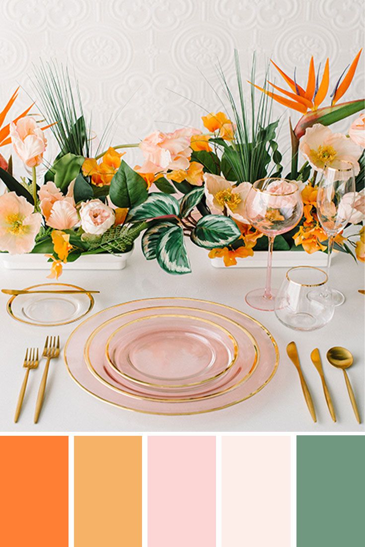 the table is set with flowers and gold cutlery, which are accented with peach hues