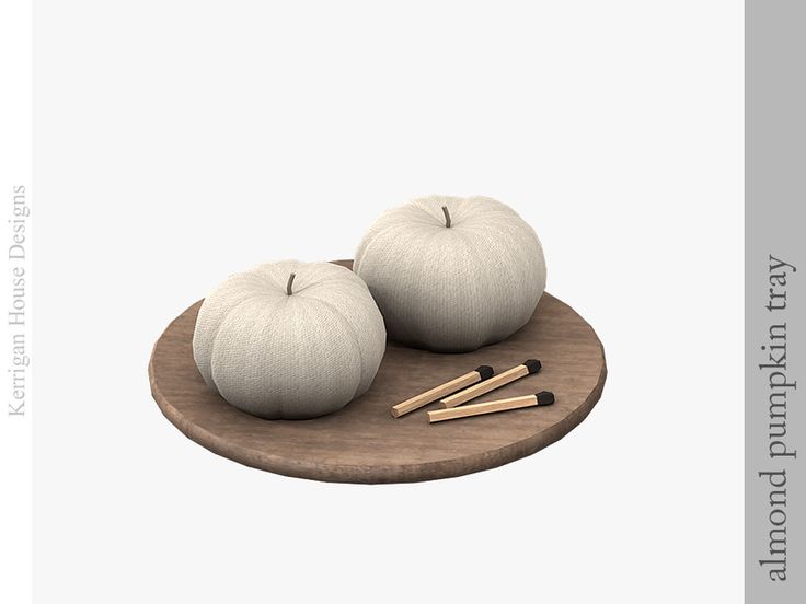 two white pumpkins sitting on top of a wooden tray next to matches and sticks