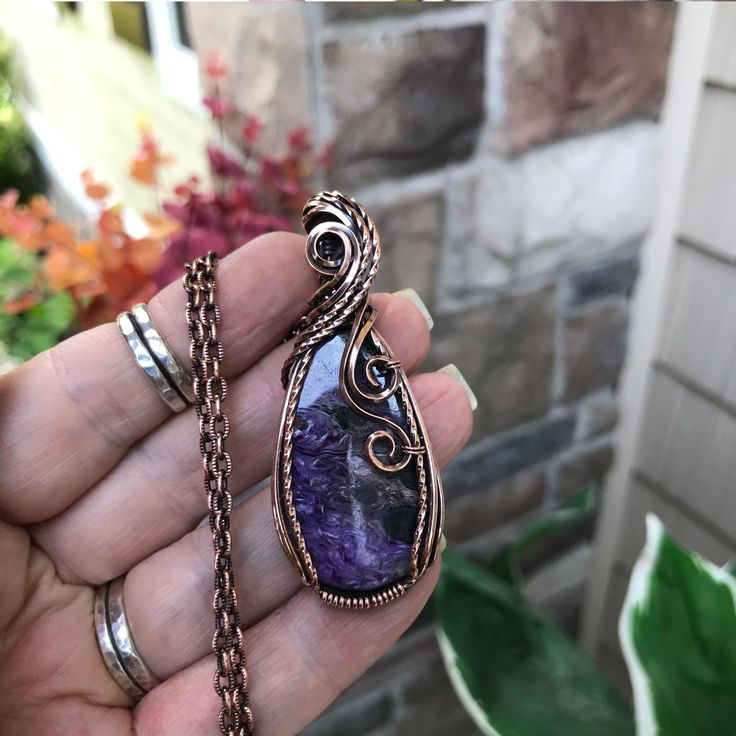 A stunning purple charoite with splashes of black and wisps of white to create a beautiful mix of colors. This pendant measures 2 1/2 x 1 inch wide.  Textured curves adorn the top and swirls cascade down one side.   Twisted wire adds sparkle. The copper has been oxidized (darkened) and polished for an antique look.  See my shop for all of my handmade jewelry  www.etsy.com/shop/moonletjewelry Bohemian Wire Wrapped Copper Jewelry, Bohemian Wire Wrapped Jewelry In Copper, Bohemian Copper Crystal Necklaces With Natural Stones, Bohemian Crystal Necklaces With Natural Stones In Copper, Bohemian Amethyst Pendant Jewelry, Hand Wrapped Purple Copper Jewelry, Purple Amethyst Bohemian Jewelry, Purple Electroformed Amethyst Jewelry, Bohemian Copper Wire Wrapped Crystal Necklaces