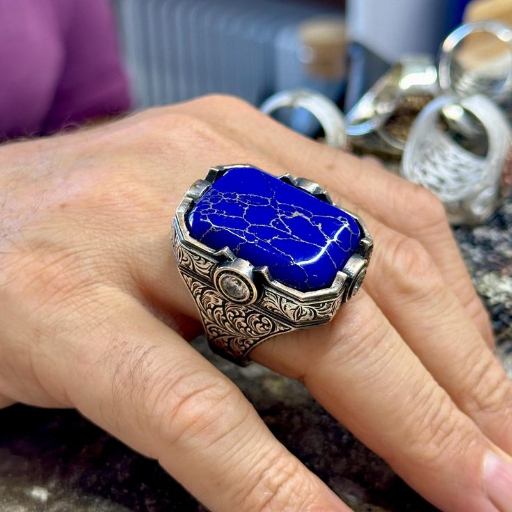 Man Silver Lapis Lazuli Ring, Blue Lapis Signet Ring, Engraved Men Silver Ring, Large 925k Sterling Silver Ring , Father Day, Gift For Him ★Item Details * Gender : Male / Female * Material : 925K Sterling Silver * Total weight :  45 Grams * Gemstone :  Lapis Lazuli Stone * Stone Size  : 22x30mm ✔ Ready to Ship in 1-2 Business Days .. ✔ Shipped to the Worldwide 1-5 business days with free shipping... ✔ The product will be sent to you with a handmade wooden box to avoid any damage during shipping... ✔ Visit our store, browse other Men's jewelry, silver and gold collections, and find the perfect piece you're looking for... -All Countries 3 - 7 Days -All Products Are Sent With Tracking Number. ( TNT , UPS , PTT ) Click For Our Other Products  https://www.etsy.com/shop/MercansilverTR?ref=simple Blue Polished Signet Ring As Gift, Blue Polished Finish Signet Ring As Gift, Blue Signet Ring With Polished Finish For Gift, Blue Signet Ring With Polished Finish As Gift, Luxury Carved Blue Jewelry, Luxury Blue Carved Jewelry, Blue Sterling Silver Signet Ring With Gemstone, Blue Engraved Ring With Polished Finish As Gift, Blue Engraved Ring With Polished Finish