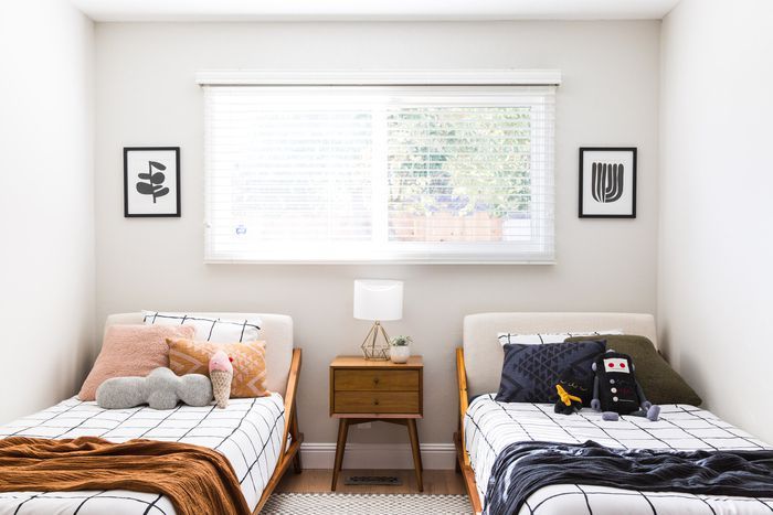 two twin beds in a small room with white walls