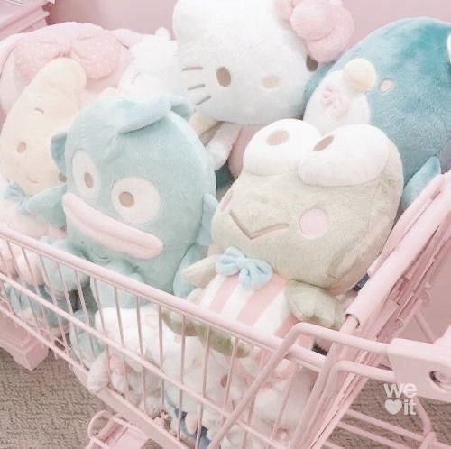 a shopping cart filled with lots of stuffed animals