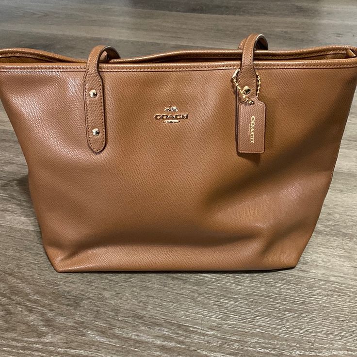 Excellent Condition Coach Handbag. I Only Used This Bag A Few Times. No Marks, Scratches Or Rips/Tears. Like Brand New. Any Questions Pls Let Me Know. Same Day Shipping If Ordered By 3pm! On-the-go Shoulder Bag With Branded Hardware, Daily Use Pouch Bags With Branded Hardware, Tan Tote Bag With Branded Hardware, Tan Bags With Branded Hardware For Everyday Use, Brown Pouch Bag With Branded Hardware, Brown Bag With Branded Hardware For Errands, Coach Everyday Tote Satchel, Satchel Bag With Branded Hardware For Everyday Use, Everyday Tote Satchel With Branded Hardware