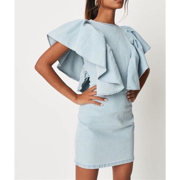 Short Extreme Ruffle Sleeve Denim Dress In A Stretchy Fabric With An Exposed Back Zip. Regular Fit Mini - Sits Mid Thigh 73% Cotton 25% Polyester 2% Elastane Spring Sleeveless Denim Dress With Ruffles, Denim Blue Mini Dress With Ruffles, Chic Denim Mini Dress With Ruffles, Sleeveless Denim Ruffle Dress, Sleeveless Denim Ruffled Dress, Sleeveless Denim Dress With Ruffles, Sleeveless Blue Denim Dress With Ruffles, Blue Sleeveless Denim Dress With Ruffles, Fitted Denim Dress With Ruffle Hem