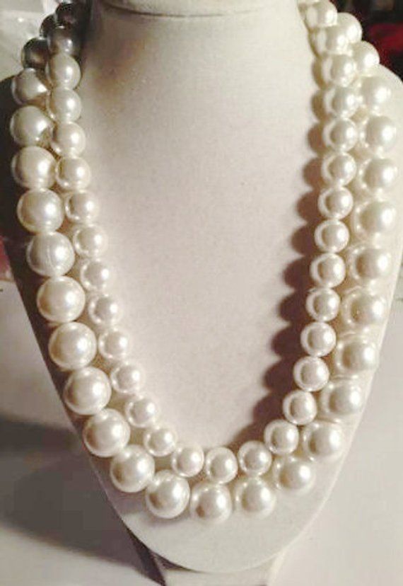 This pearl necklace created by Jewelry by CARMAL is made of: two sizes of white pearls, sterling silver hook and chain clasp and findings. This necklace measures 20 to 21 1/2 inches in length depending upon where you hook the clasp. The pearl is the birthstone of June. White is associated with light, goodness, innocence, purity, and virginity. It is considered to be the color of perfection. The pearl is also the gemstone for the 30th wedding anniversary! Pearls can be trendy or traditional and e Gray And White Pearl Necklace, White Pearl Chain Necklace For Formal Occasions, Formal White Pearl Chain Necklace, Anniversary White Pearl Chain Necklace, Formal White Bridal Necklace With Pearl Chain, Formal White Pearl Embellished Necklaces, White Pearl Chain Necklace For Anniversary, White Single Strand Pearl Necklace For Anniversary, White Pearl Embellished Necklaces For Anniversary