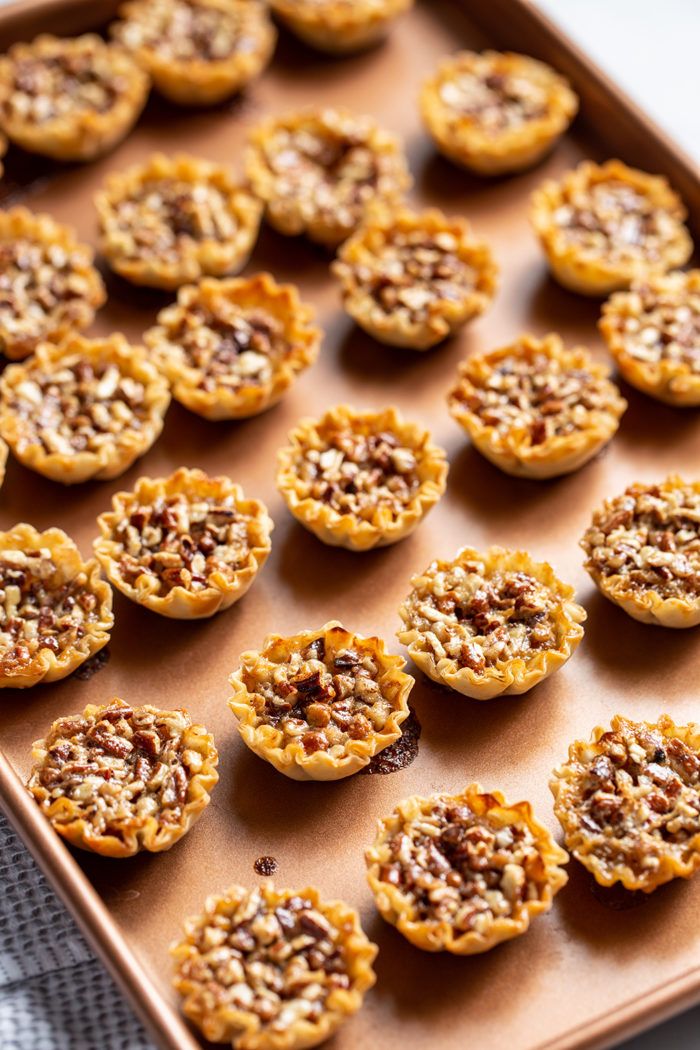 small desserts are arranged on a baking sheet and ready to be baked in the oven