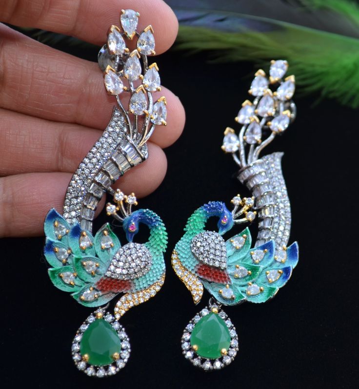 American Diamond Earrings/Meenakari Earrings/Indian Jewelry/Pakistani Jewelry/Bollywood Jewelry/Statement Earrings/Partywear Earrings/Ad/CZ A premium quality CZ- studded & baguette diamond Peacock-Shaped Meenakari Earrings. Comfortable to wear. Light weight  Length: 3" Finish: Victorian Finish  Push-Back closure. Availability: In-Stock *Color may vary slightly due to light condition & photography. Jewelry Care:  Keep away from moisture. Allow perfumes and lotion to dry before wearing. Store in j Partywear Earrings, American Diamond Earrings, Meenakari Earrings, Photography Jewelry, Peacock Jewelry, Jewelry Pakistani, Peacock Earrings, Earrings Indian, Bollywood Jewelry