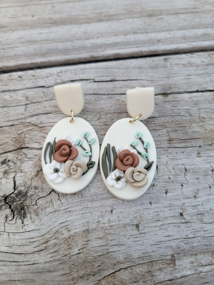 Lightweight clay floral dangle earrings. Dangle Earrings With Flower Charm In Polymer Clay, Handmade Flower Dangle Earrings In Polymer Clay, Handmade Flower Dangle Jewelry In Polymer Clay, White Hand Painted Polymer Clay Flower Earrings, Handmade Clay Flower Drop Earrings, Vintage Roses, Dangle Earrings, Stud Earrings, Drop Earrings