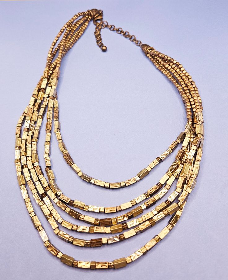 Very beautiful vintage multi strand goldtoned necklace by Chico's! Layered Multi-strand Metal Jewelry, Multi-strand Gold Beads Costume Jewelry, Elegant Multi-strand Chain Necklace With Gold Beads, Adjustable Gold Metal Layered Necklace, Adjustable Gold Layered Metal Necklace, Adjustable Gold Multi-strand Jewelry, Adjustable Gold Layered Necklace, Gold Multi-strand Necklace With Gold Beads, Adjustable Multi-strand Gold Jewelry