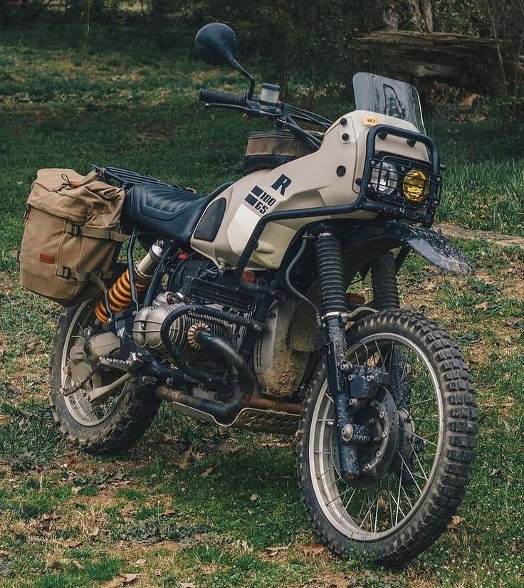 a dirt bike parked on top of a lush green field