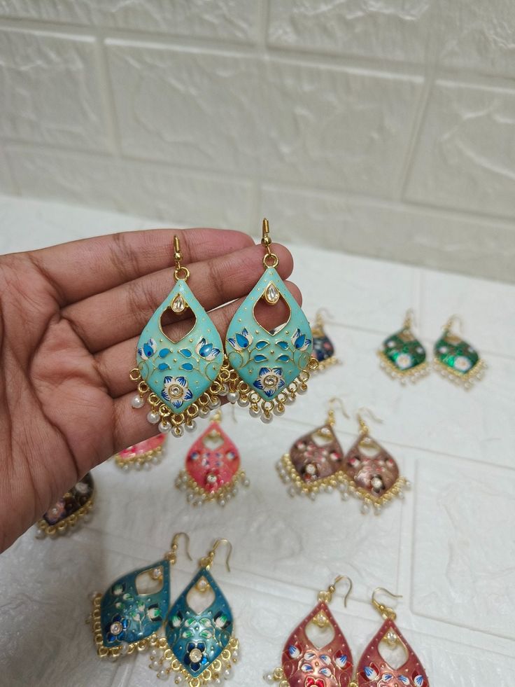 Product Item: Kundan/ Meenakari Earrings for favors Size : 2.5 Inch Approx Color: Assorted Color Will Be Send Materials: Metal Location: Earlobe Closure: Ear wire/ hook Traditional Indian Bolywood Ethnic Earrings For Women. These Meenakari earrings are the perfect blend of tradition and modernity, featuring assorted colors and captivating designs. They make fantastic gifts for guests, perfect for weddings, mehndi, sangeet ceremonies, and an ideal option for bridesmaid gifts. If you're looking to Festive Bridal Earrings With Meenakari, Handmade Blue Danglers For Wedding, Festive Peacock Design Drop Earrings, Festive Peacock Design Earrings, Blue Cutdana Earrings For Wedding, Traditional Bridal Earrings With Cutdana For Gifts, Green Bridal Earrings With Cutdana As Gift, Green Cutdana Bridal Earrings As Gift, Festive Peacock Design Drop Danglers