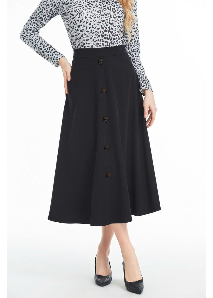 Our Black Midi Skirt with Front Button Detail is the perfect blend of sophistication and style. Crafted from high-quality denim fabric, this skirt is soft to the touch and comfortable to wear. It features a midi length, which falls below the knee, making it perfect for both casual and formal occasions. The skirt is designed with a button detail that runs down the front of the skirt, adding a touch of elegance and femininity to the overall design. The skirt also features a hidden back zipper clos Black Midi Skirt, Black Midi, Denim Fabric, Button Detail, Formal Occasion, Modern Woman, Midi Length, The Knee, Midi Skirt