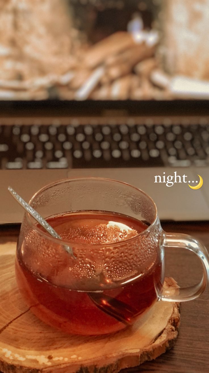 a cup of tea sitting on top of a wooden coaster