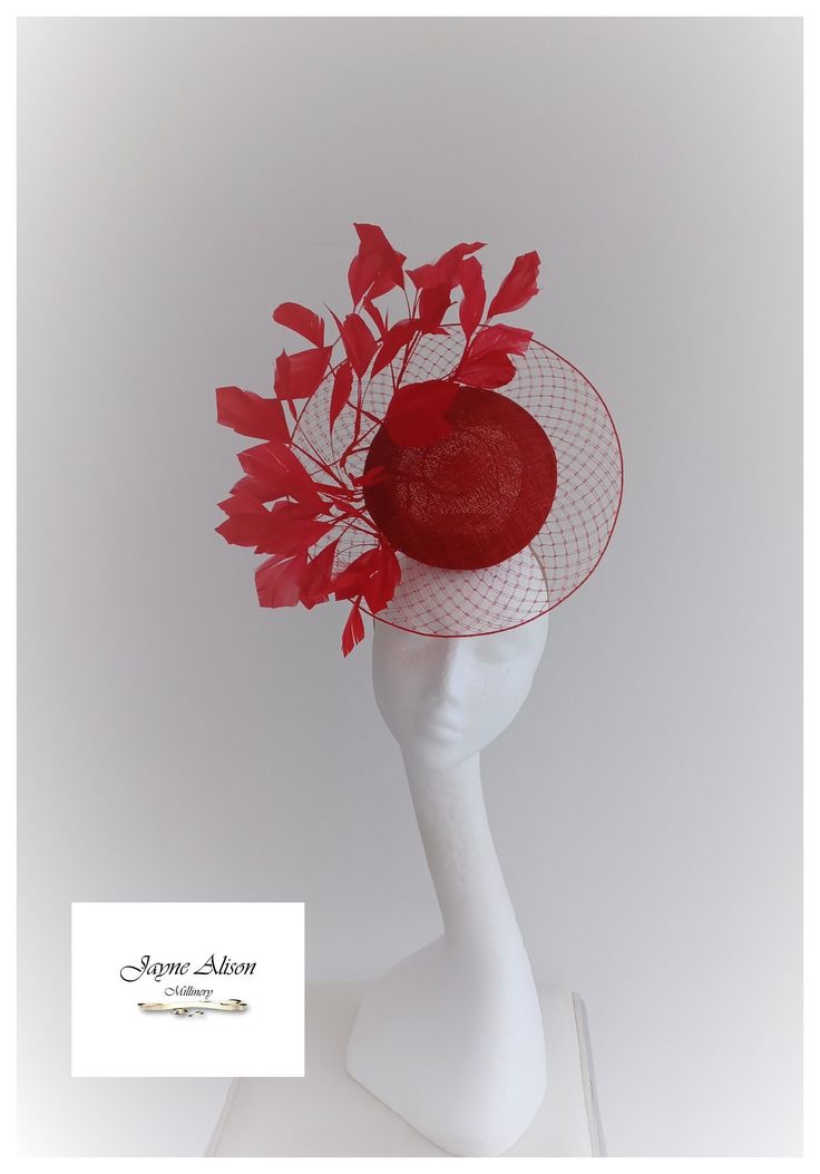 'Make an entrance with this veiled percher style headpiece in deep red.  A sinamay button encases a red veiling disc, whilst cut goose feathers twist and turn as they emerge from the centre.  Sits on a percher headband. This item has sold, however, similar pieces can be made in a variety of colours.  Please ask for details.  As every piece is handmade, some differences can occur from the photos listed on this site.  Made to order/bespoke/custom orders are non-refundable/returnable. Please read o Luxury Red Short Brim Fascinator, Red Structured Crown Headpiece For Wedding, Red Structured Crown Hat For Weddings, Red Structured Crown Costume Hat For Wedding, Red Structured Crown Headpiece For Party, Red Fascinator For Spring Events, Red Headpiece With Structured Crown For Party, Red Structured Crown Hat For Evening, Red Hat For Royal Ascot Event