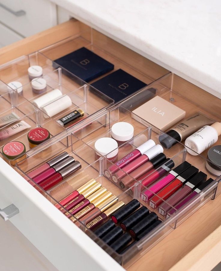 the drawers are filled with various cosmetics and makeup products