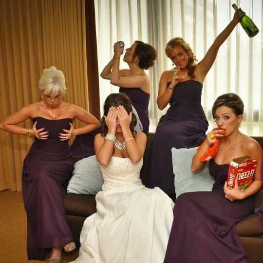 bridesmaids in purple dresses sitting on couches and one woman covering her eyes