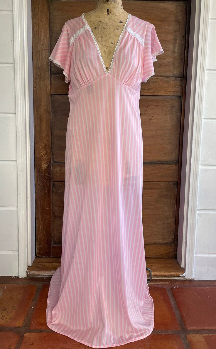 1970s Pink Striped Flutter Sleeve Nightgown Size: medium Brand: at ease Material: nylon Measurements taken flat Pit to pit: 17.5" Waist: 17" Length: 53" Please note that all items are vintage or previously loved and may show signs of wear. Any major wear to the pieces will be noted & photographed. Sheer V-neck Summer Nightgown, Fitted Vintage V-neck Nightgown, Sheer V-neck Nightgown For Sleepover, Sheer Nightgown For Spring Sleepover, Vintage Ruffled Nightgown For Loungewear, Spring Vintage V-neck Nightgown, Vintage Sheer Nightgown For Summer, Vintage Nightgown With Ruffles For Loungewear, Vintage V-neck Nightgown For Spring