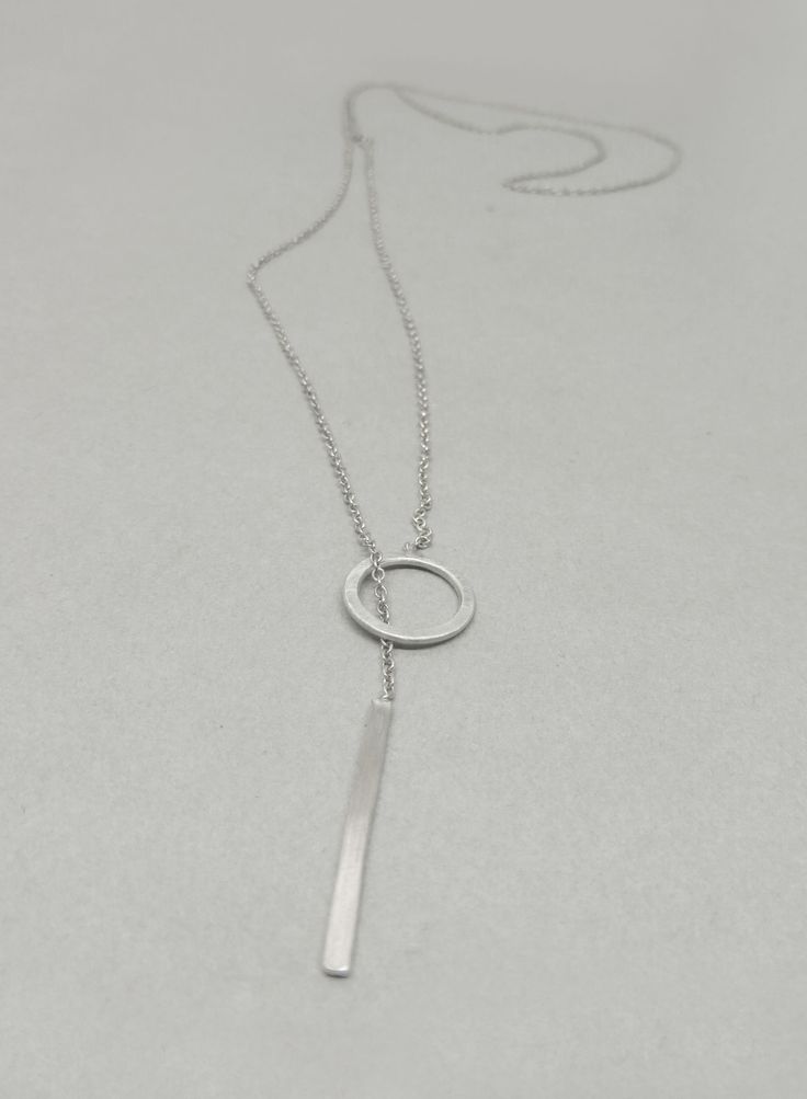 This Lariat necklace is totally handmade made from sterling silver. A dainty necklace that adjusts to any outfit. Great layering charm necklace, easy to wear on its own too. The diameter of the circle is 12 mm and the bar is 20 mm long. Length: 52 cm -----> 20 inches 62 cm -----> 24 inches 72 cm -----> 28 inches Feel free to ask for a different length. The necklace above is not the exact one you will receive. Each one is handmade to order and may slightly vary from the pictures. Please Minimalist White Gold Lariat Necklace With Delicate Chain, Sterling Silver Clavicle Chain Lariat Necklace For Everyday, Sterling Silver Lariat Necklace For Everyday, Everyday Sterling Silver Lariat Necklace With Clavicle Chain, Everyday Sterling Silver Lariat Necklace, Minimalist White Gold Sterling Silver Lariat Necklace, Minimalist White Gold Lariat Necklace, Silver Minimalist Lariat Necklace With Delicate Chain, Modern Silver Lariat Necklace In Sterling Silver