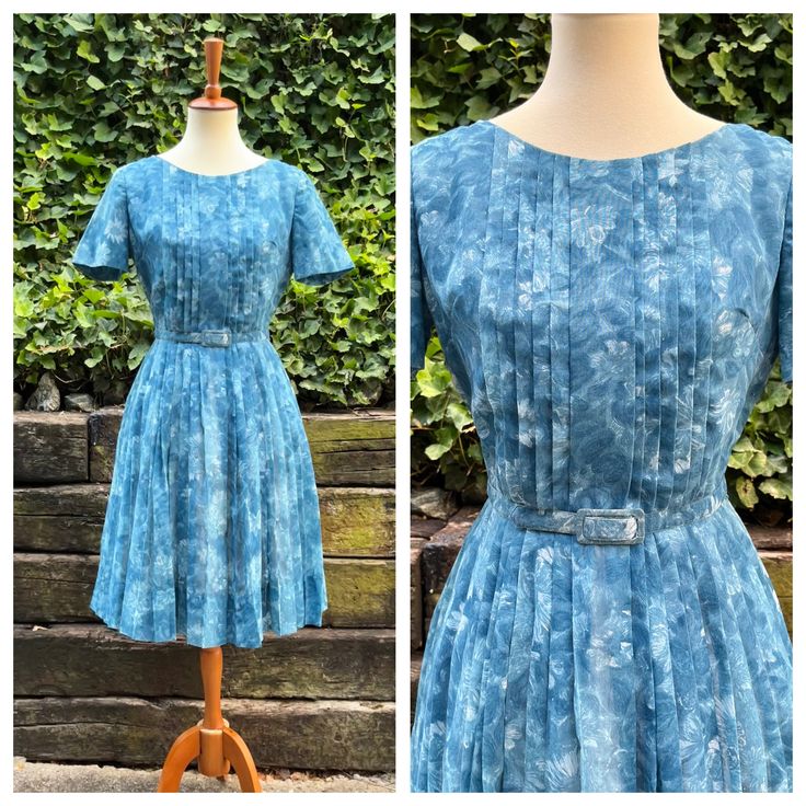 A sweet early 1960s blue day dress, featuring an abstract floral print and pin tuck pleats across the bodice. It zips up a back and has a matching adjustable belt. I've washed this dress, and it's ready to wear!  It's in excellent vintage condition. Along with its tag, the last photo block shows a light stain on the sleeve and wear on the belt. There is light underarm yellowing that gets lost in the pattern.  Modeled with a petticoat that is not included.  Measurements  Bust: 36-37 inches  Waist: 27 inches Hips: open  Bodice length: 15 inches  Skirt length: 24 inches  Modeled on a 34/26/35 mannequin.  From a smoke and pet free home. I ship Monday, Wednesday, and Friday. I do not offer returns, so please reach out with any questions or to ask for additional photos/measurements. Pleated 1950s Style Spring Dresses, 1950s Style Spring Pleated Dress, Fitted Pleated Vintage Summer Dress, Summer Pleated Dresses For Vintage Fashion, Summer Pleated Vintage Dresses, Mid-century Blue Spring Dresses, Pleated Vintage Dress For Summer, Retro Summer Dress With Box Pleat, Blue Day Dress