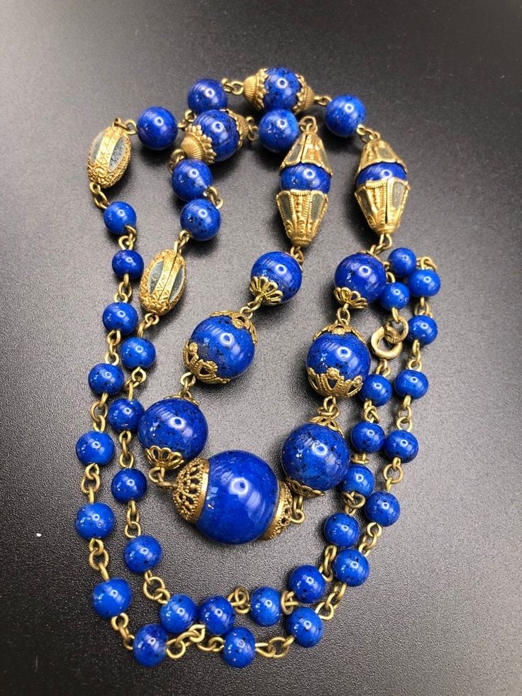 "Neiger Brothers Lapis blue glass beaded necklace with enamelled bead caps and metal beads.  Lovely array of pretty bead caps, a long length in great condition. The beads have gold flecks in them and the bolt ring clasp has Czechoslov impressed in it. Length: end to end 28\" Centre bead with bead caps = 3/4\"" Vintage Necklace With Bead Caps And Round Beads, Vintage Necklaces With Round Beads And Bead Caps, Vintage Necklaces With Bead Caps And Round Beads, Vintage Beaded Necklace With Bead Caps, Vintage Blue Oval Bead Necklace, Vintage Blue Necklace With Oval Beads, Vintage Blue Necklaces With Oval Beads, Vintage Blue Beaded Chain Necklace, Vintage Blue Necklace With Beaded Chain