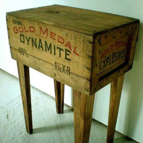 an old wooden box that has been turned into a side table with writing on it