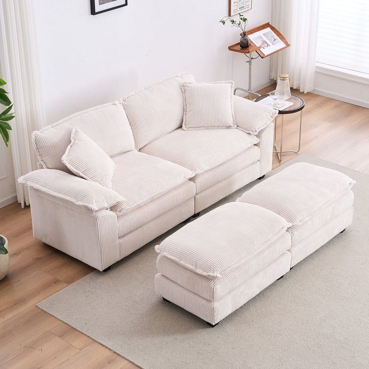 a white couch and ottoman in a living room