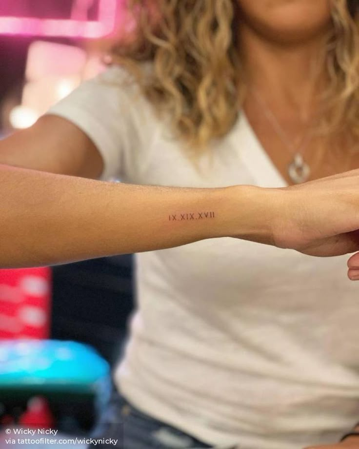 a woman with a small tattoo on her arm