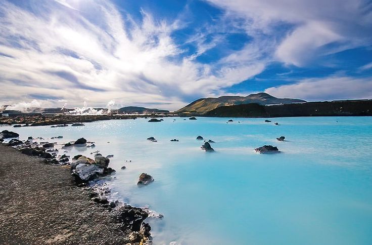 the water is blue and there are rocks in it