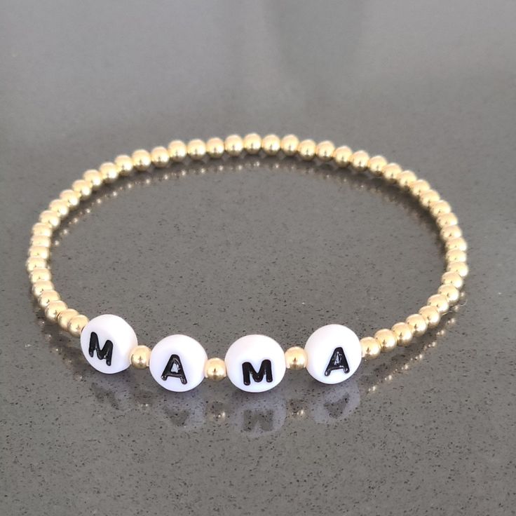 "* 3 mm Gold Filled (14/20) Beads * MAMA Bracelet -- Personalized with your name or message Available in Various Sizes. Please choose from drop down list. I make 6.5\" for most wrist size To determine your bracelet size: Measure with a tape around your wrist (where you would like the bracelet to sit). If you don't have access to a measuring tape, wrap a string around your wrist and measure the length with a ruler. This is your wrist size. To determine your bracelet size add 1/2\" for a snug fit Personalized Meaningful Beaded Bracelets As Gift, Meaningful Adjustable White Name Bracelet, Personalized Round Bracelets For Gifts, Personalized Round Bracelet As A Gift, Meaningful Hypoallergenic White Bracelets, Meaningful White Bracelet Jewelry, Meaningful White Jewelry With Letter Beads, Meaningful Everyday White Jewelry, Adjustable Meaningful Bracelets With Custom Name