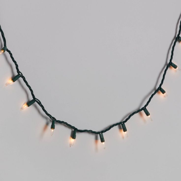 a string of christmas lights on a white background