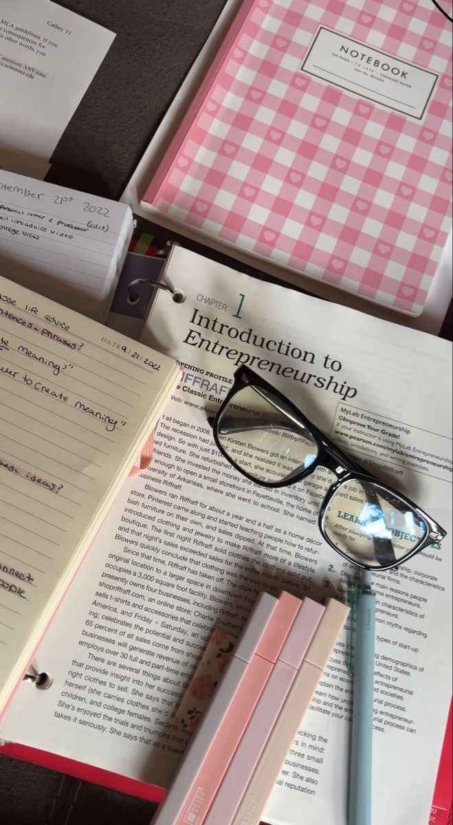 several books and glasses sitting on top of each other next to an eyeglasses