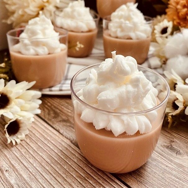 small desserts with whipped cream and flowers in the background