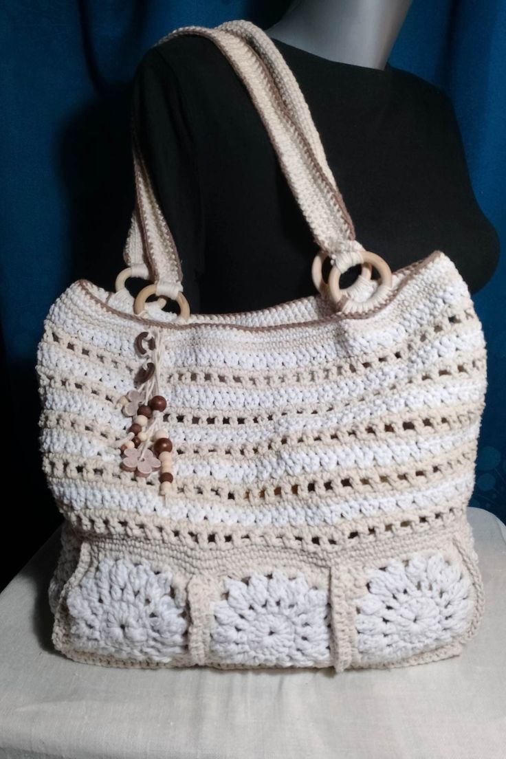 Crocheted shopping bag that has a small wallet that can be removed to help you leave your personal belongings so they won't get lost. It can be used for the beach as well as for shopping in stores. The size is not too big but also not too small. It is crocheted from cotton twine, very durable and strong, so that the bag can bear the weight. It can be used mostly in the summer months, but also throughout the year. The colors are bright and fit mostly with any everyday outfit. Size: 32 cm with 40 cm bag handles 59cm long with 3.5cm wide, the height from the top of the bag to the top of the bag handles is 33cm  wallet  15cm with 9cm material: 100% cotton twine wooden ornaments and wooden hoops The bag is unique and there is only one! White Handheld Crochet Bag For The Beach, White Handheld Crochet Bag For Vacation, White Handheld Crochet Bag For Beach, Summer White Crochet Bag With Top Carry Handle, White Handheld Crochet Beach Bag, White Crochet Bag With Top Carry Handle For Summer, White Beach Bag With Top Carry Handle, Travel Crochet Bag With Removable Pouch And Double Handle, Lightweight Cream Bag For The Beach