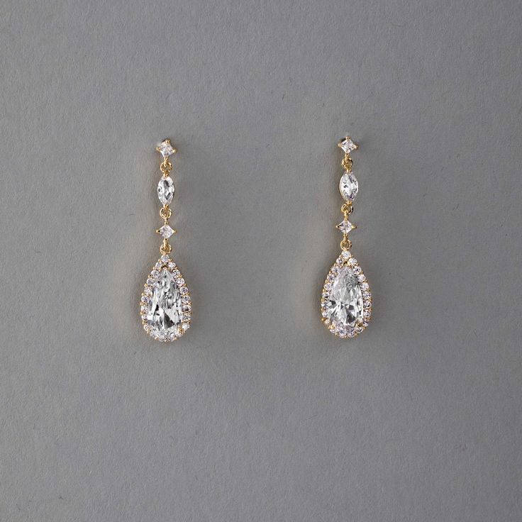 Enhance your bridal ensemble with these exquisite wedding earrings featuring a pave set elongated pear drop, delicately suspended from petite round and marquise CZ stones.They are 1.5 inches long, post pierced backs, rhodium, rose gold or gold plated, grade AAA CZ stones, lead, cadmium, and nickel free. Prom Accessories Earrings, Gold Crystal Earrings, Maid Of Honor Earrings, Homecoming Earrings Gold, Wedding Earrings For Bride, Prom Jewlrey Looks Gold, Gold Earrings Formal, Prom Jewlrey Looks, Gold Crystal Earrings For Wedding