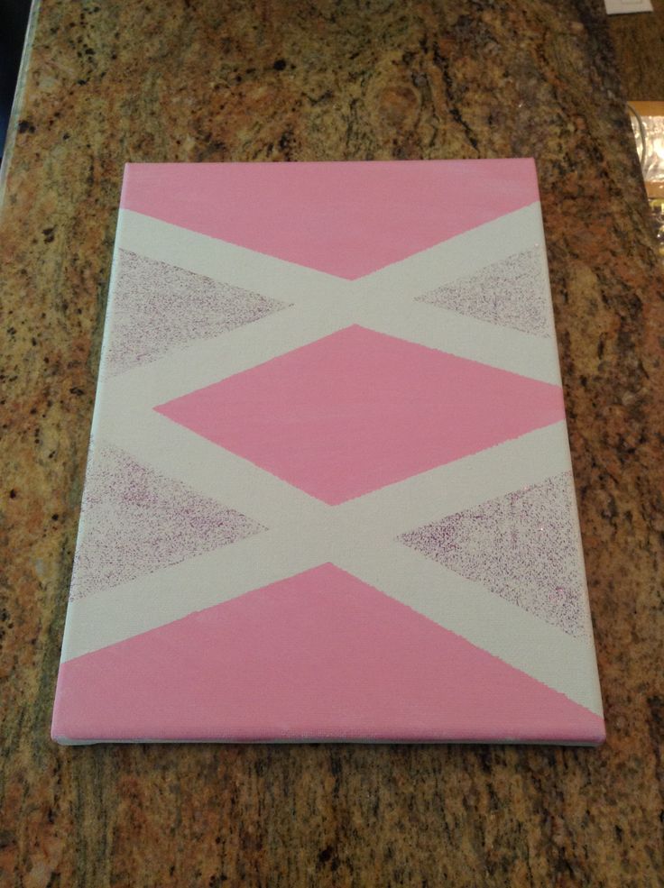 a pink and white painting on top of a counter