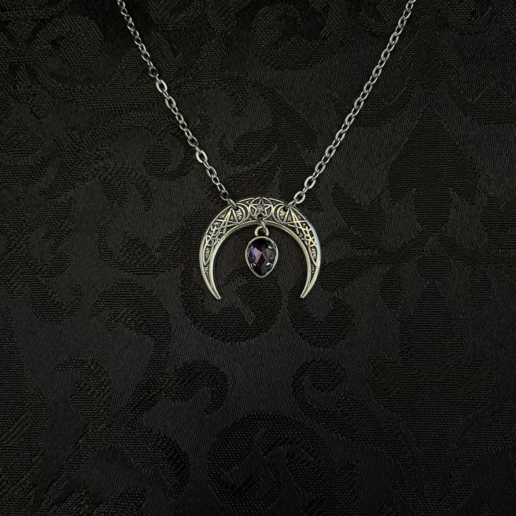 "This simple pendant features a richly detailed antiqued silver tone crescent, adorned with dazzling dark purple glass crystals. Pendant is 1 1/8\" wide and 1\" tall.  Necklace length is adjustable with soldered stainless steel cable chain, lobster clasp and extender. If you would like a different length, please send us a message. Matching headpiece, pendant and earrings are listed separately in our store. If you don't see items with a color you want, feel free to ask about availability." Gothic Silver Crescent Necklace, Gothic Crescent Silver Necklace, Adjustable Purple Moon Phase Jewelry, Gothic Festival Jewelry With Moon Charm, Witchy Metal Jewelry With Moon Charm, Silver Moon Shaped Witchy Jewelry, Antique Silver Gothic Round Jewelry, Gothic Moon-shaped Jewelry Gift, Silver Metal Witchy Jewelry