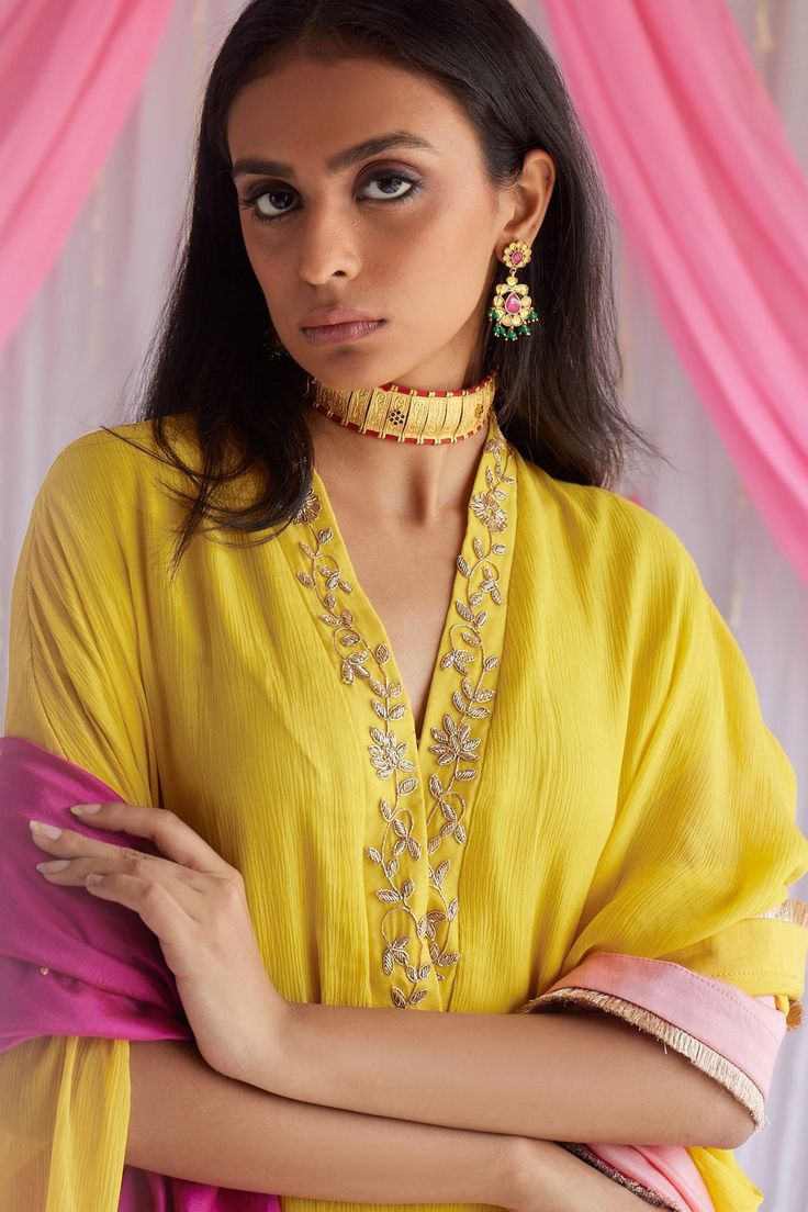 Marigold yellow kaftan in chiffon base with floral motif hand embroidered neckline.
Component: 1
Pattern: Embroidered
Type Of Work: Floral Motifs
Neckline: V-Neck
Sleeve Type: Three Quarter
Fabric: Chiffon, Lining: Shantoon
Color: Yellow
Other Details: 
Side drops
Note: The dupatta worn by the model is not for sale
Occasion: Party - Aza Fashions Elegant Yellow Traditional Wear For Festive Occasions, Elegant Festive Palazzo Set With Embroidered Neckline, Elegant Yellow Anarkali Set For Designer Wear, Elegant Designer Yellow Anarkali Set, Traditional Yellow Georgette Palazzo Set, Elegant Yellow Georgette Anarkali Set, Elegant Yellow Traditional Wear With Gota Work, Gold Anarkali Kaftan For Wedding, Elegant Yellow Anarkali Set For Navratri