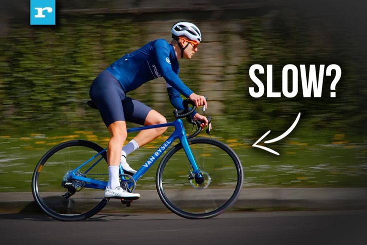 a man riding a bike down a street with the words slow written on it's side