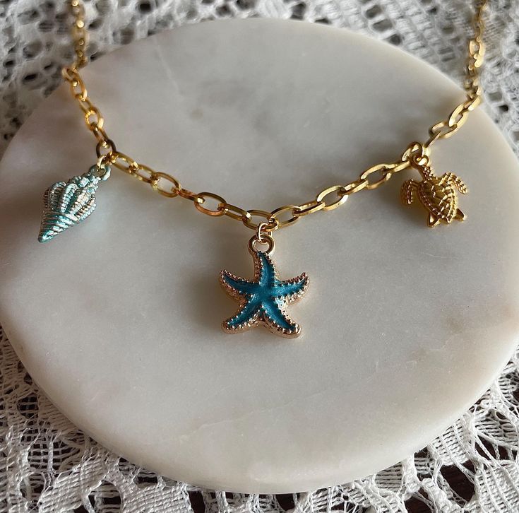 Gold stainless steel necklace with three charms: shell (blue), starfish (blue) and turtle (gold). The perfect necklace for summer. Among the orders of the week, I regularly draw lucky people who will receive a small gift in their package. ~ Packaging ~ Each piece of jewelry is carefully positioned in an airtight pink bag, accompanied by a thank you card, all packaged in a bubble envelope. ~Shipping~ Upon receipt of the order, the jewelry is sent as quickly as possible, within one hour to 24 hours depending on the time at which you place the order. One goal: to ship it as quickly as possible so that you receive it as quickly as possible. ~ Mentra ~ Made in the Basque Country, in the South West of France, my jewelry is made with love and attention to detail. Follow me on Instagram @superstit Blue Starfish, Jewelry Ocean, Ocean Necklace, Turtle Charm, Necklace Boho, Steel Necklace, Small Gift, Beach Jewelry, Stainless Steel Necklace