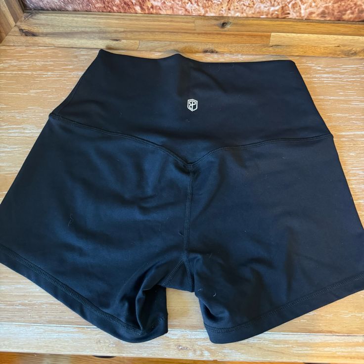 Never Worn, Black And Stretchy. Casual Black Yoga Shorts, Black Compression Athletic Shorts With Elastic Waistband, High Waist Black Bottoms With Moisture-wicking, High Waist Moisture-wicking Black Bottoms, High Waist Black Moisture-wicking Bottoms, High Waist Black Biker Shorts For Yoga, Black High Waist Biker Shorts Sportswear, High Waist Black Yoga Biker Shorts, Black Yoga Bottoms With Built-in Shorts