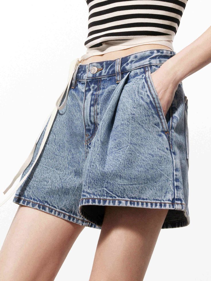 MO&Co. Women's Pleated Detail Denim Shorts Few pieces signal summer quite like a pair of denim shorts. Washed a blue hue, this style is crafted from an organic cotton and shaped with mini cut, pleated design and a slight flare to the leg. Pair with our top for a chic and relaxed look. Features : - Relaxed fit- Vintage texture and slight flare hem- Pleated design, button and zip closure Code: MBD2SOTT56The back length of size S/26 is 33.9cmMATERIALS & CARE Material: 100% CottonDenim products have Spring Cutoff Shorts With Pockets, Summer High-waisted Jean Shorts With Belt Loops, Summer Jean Shorts With Belt Loops, Short Jean Shorts With Belt Loops For Summer, Denim Shorts With Belt Loops, Medium Wash Cotton Shorts, Summer Mid-rise Jean Shorts With Belt Loops, Denim Blue Shorts For Summer, Mid-rise Jean Shorts With Belt Loops For Summer