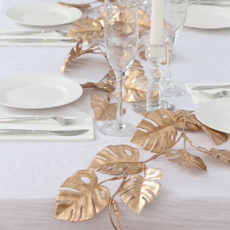 7ft Gold Artificial Monstera Leaf Garland | eFavormart.com Monstera Leaf Table, Stair Banister, Table Garland, Artificial Garland, Faux Leaf, Hanging Vines, Elegant Vases, Artificial Leaf, Hanging Garland