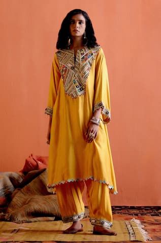 Mustard yellow kurta with multicolor thread, mirror embroidered yoke in geometric pattern. Paired with pathani salwar.
Components: 2
Pattern: Embroidery
Type Of Work: Thread, mirror
Neckline: Notched
Sleeve Type: Long sleeves
Fabric: Cheeniya Silk
Color: Yellow
Other Details: 
Embroidery on salwar hem
Occasion: Sangeet - Aza Fashions Yellow Bohemian Festive Sets, Bohemian Festive Yellow Set, Unstitched Bohemian Yellow Salwar Kameez, Yellow Bohemian Straight Kurta Set, Bohemian Yellow Sets With Resham Embroidery, Yellow Traditional Wear Straight Kurta With Mirror Work, Yellow Traditional Wear With Mirror Work Straight Kurta, Yellow Kurta With Mirror Work For Navratri, Yellow Mirror Work Kurta For Diwali