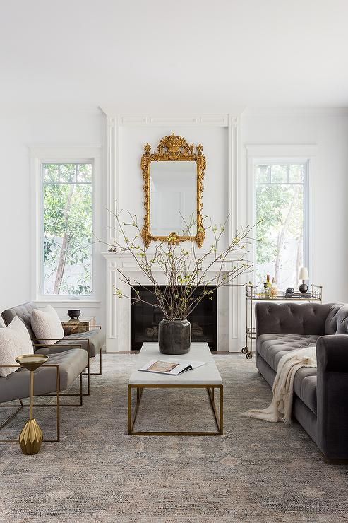 a living room filled with furniture and a fire place in the middle of a room